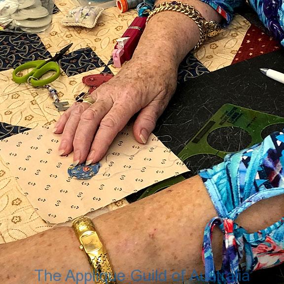 image of Mary demonstrating Perfect hand appliqued Needle-turn circles